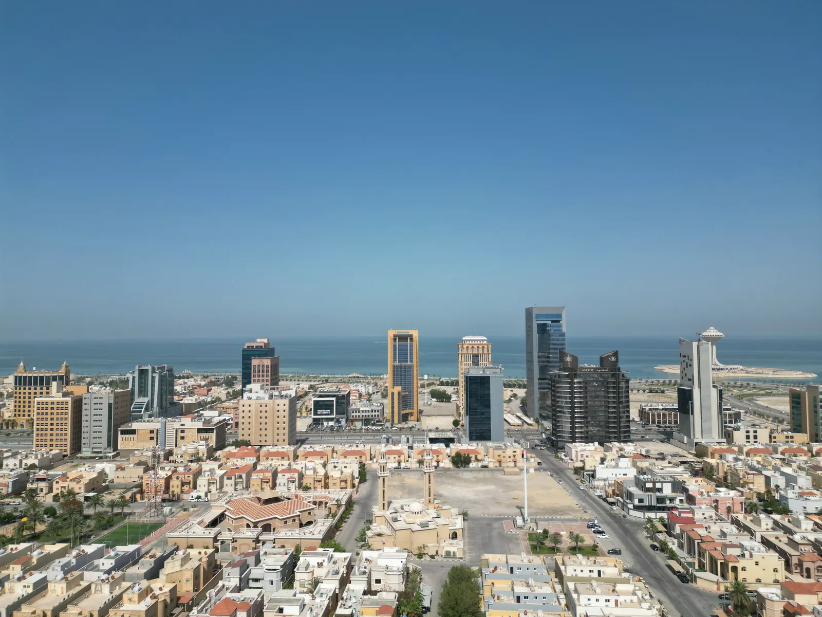 منظر عمودي لسطح البرج: الأسطوانة البيضاوية بين معدات السطح، وتحتها الطريق والمساحات المزروعة.