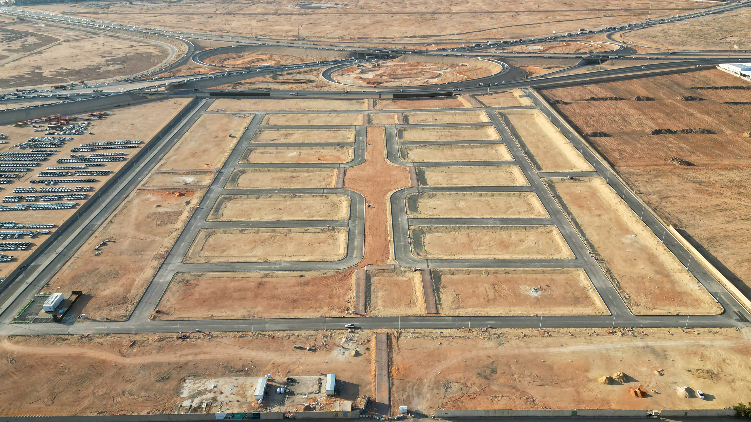 Mshargeya Gate from the air in January 2026: the scheme's paved streets and serviced plots