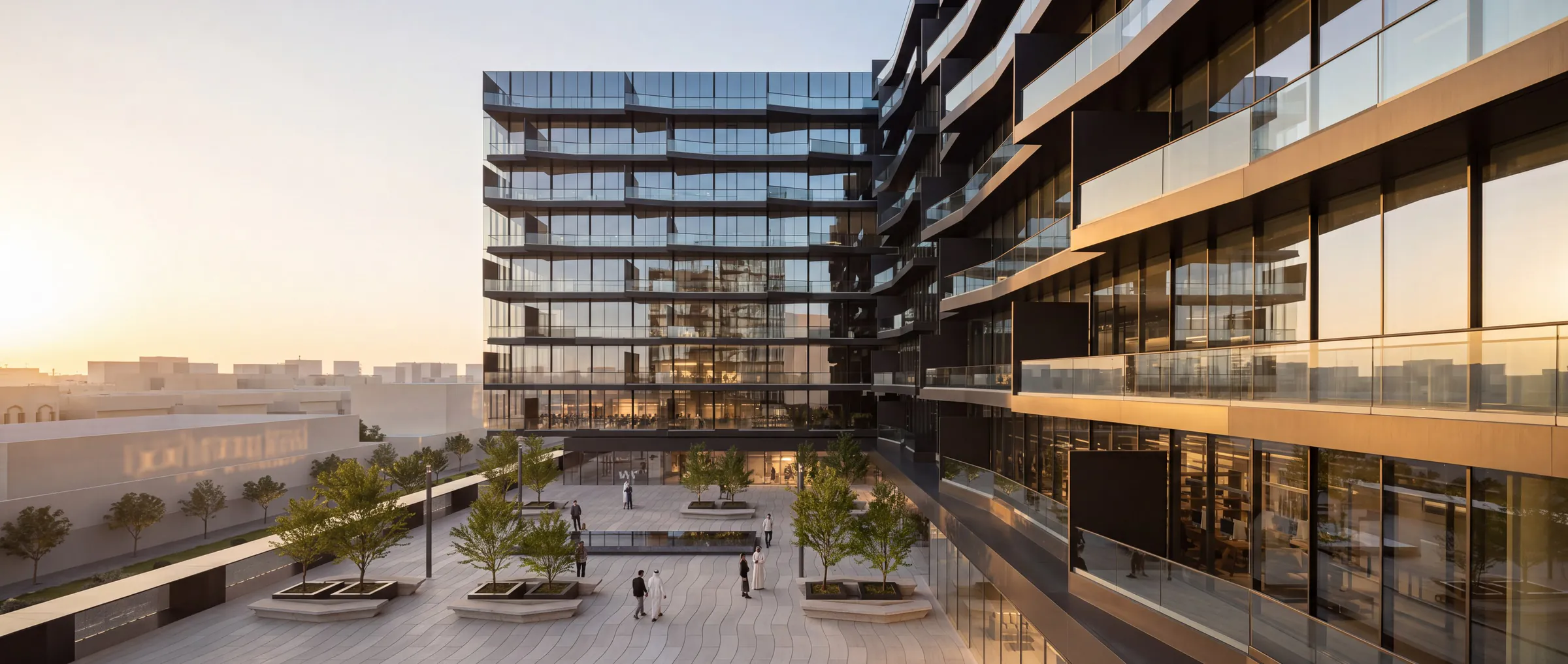 The podium deck at sunset, with the main building and the tower beyond.